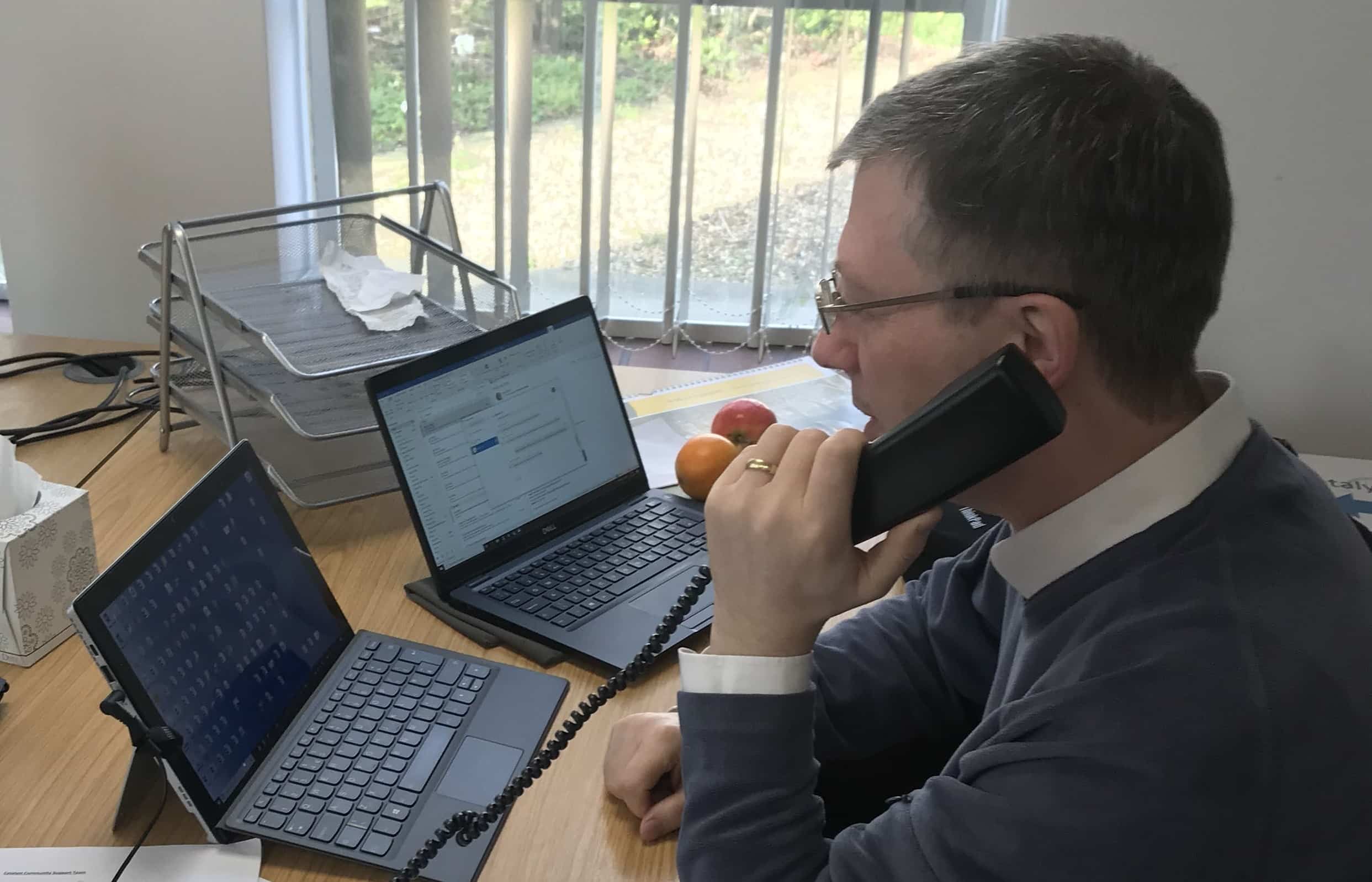 A member of the COVID Community Support Team talking on the phone