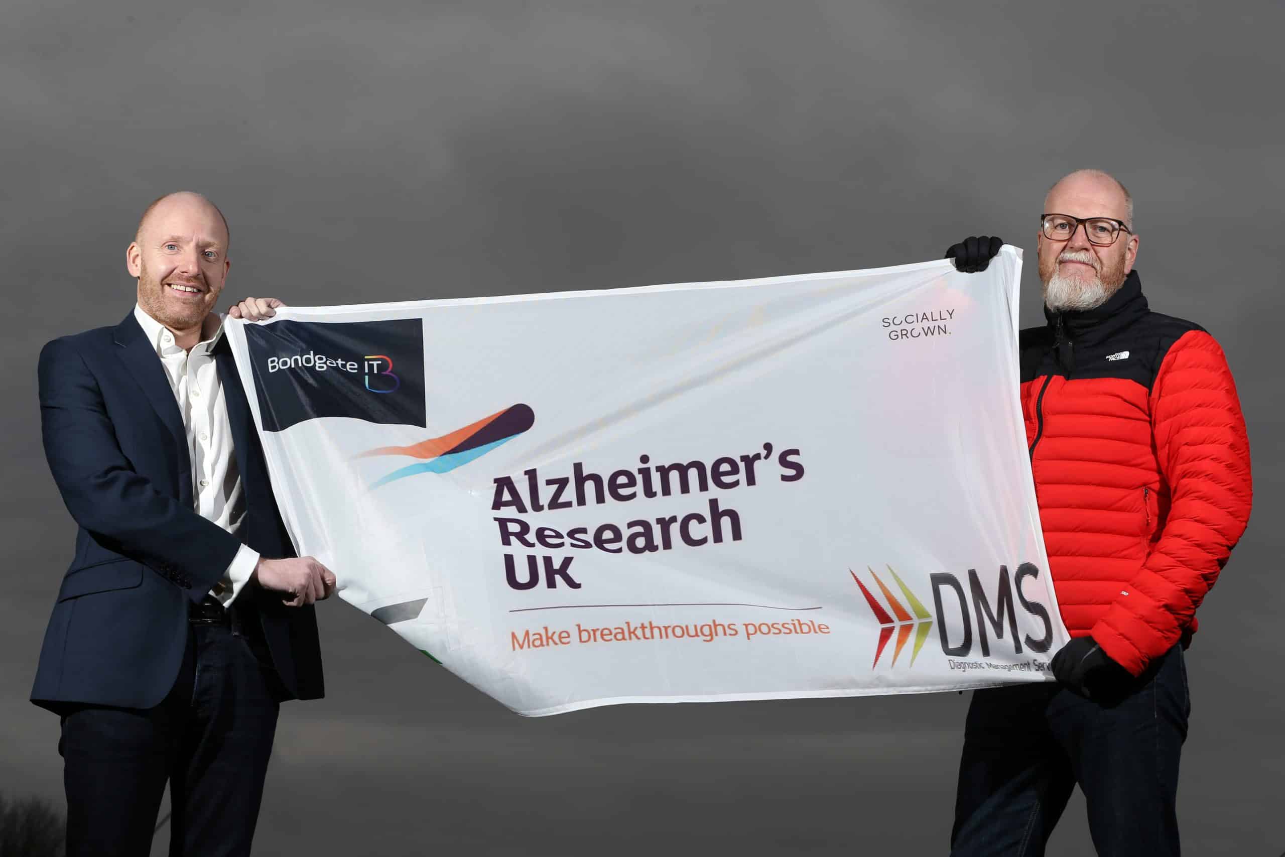 Garry Brown and Mitchell Smith with the flag he will unfurl at Everest Base Camp